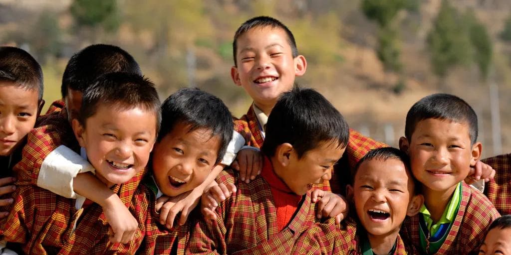 The Explorers witness Bhutan’s joy: children laughing together in traditional attire